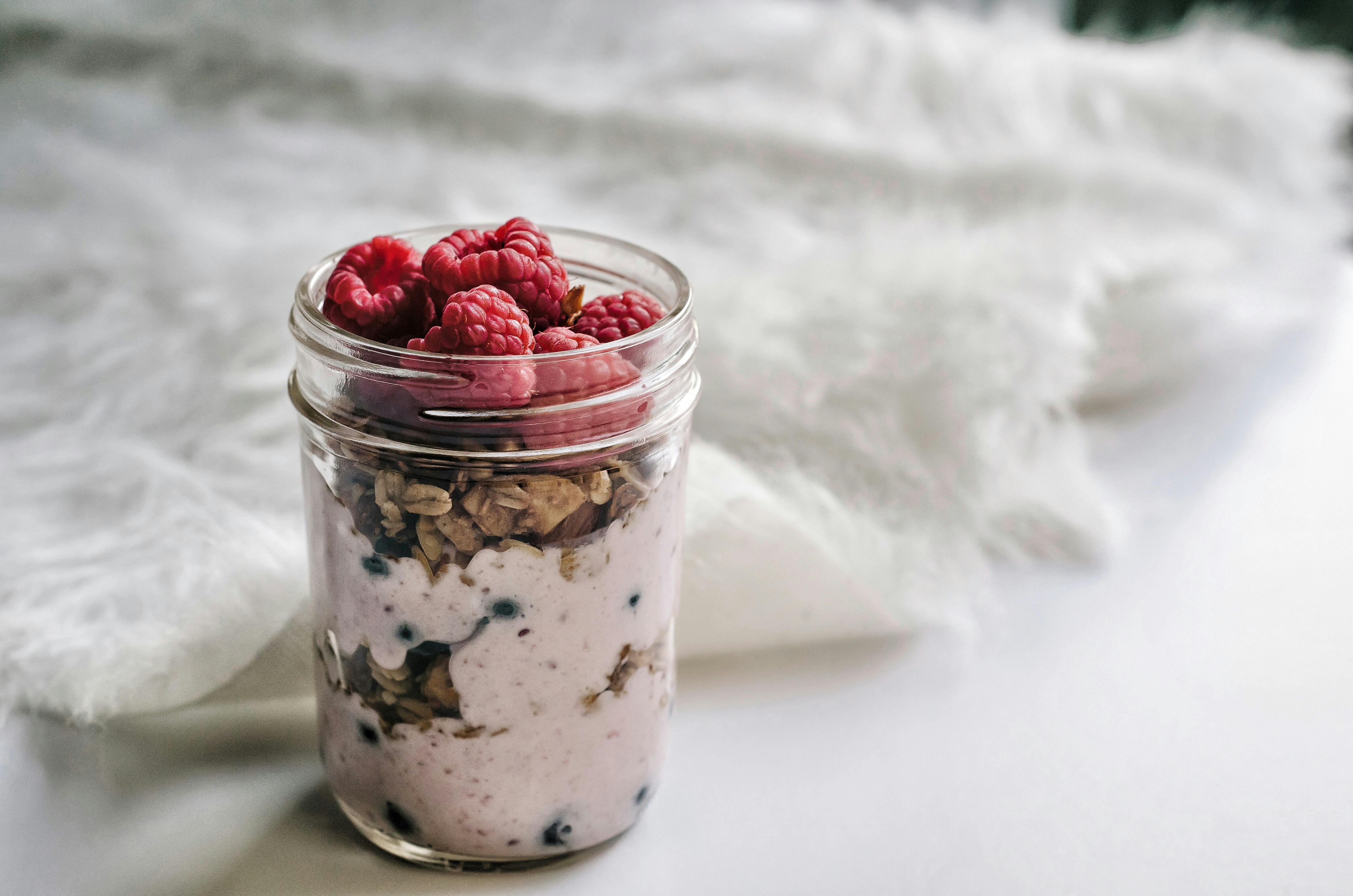 Creamy overnight oats with fresh berries in mason jars, perfect make-ahead breakfast for busy families