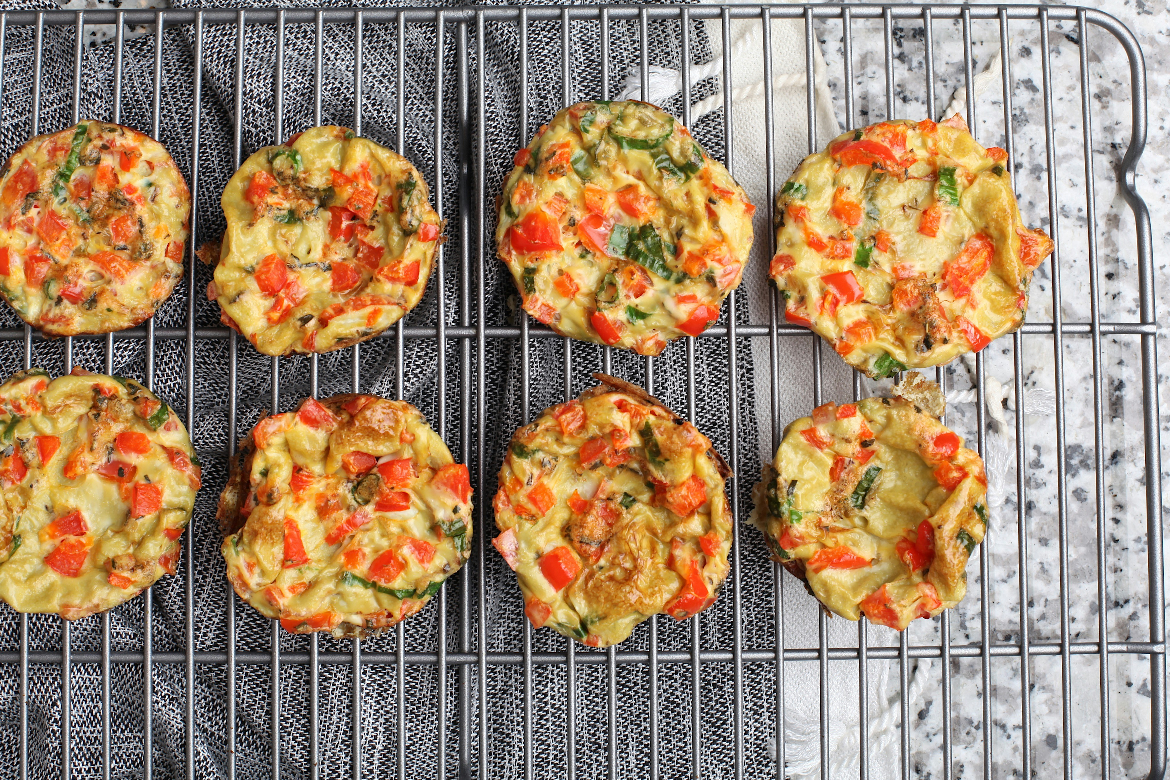 Golden mini egg muffins with vegetables and cheese, perfect grab-and-go protein breakfast for busy families